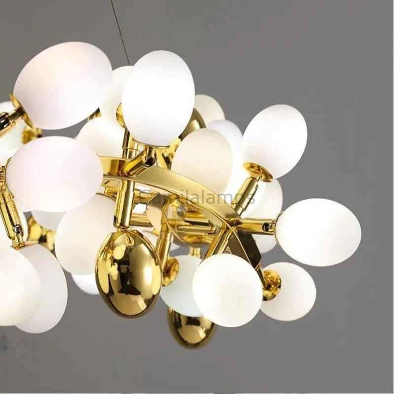 The collection of chandeliers is inspired by the growth dynamics of the vine plant grape. The frame of the branches is handmade and the cups are made of balls in the shape of grapes in milk white and gold. It is an elegant and charming lamp for banquets, living room foyers.