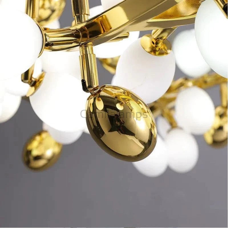 The collection of chandeliers is inspired by the growth dynamics of the vine plant grape. The frame of the branches is handmade and the cups are made of balls in the shape of grapes in milk white and gold. It is an elegant and charming lamp for banquets, living room foyers.