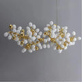 The collection of chandeliers is inspired by the growth dynamics of the vine plant grape. The frame of the branches is handmade and the cups are made of balls in the shape of grapes in milk white and gold. It is an elegant and charming lamp for banquets, living room foyers.