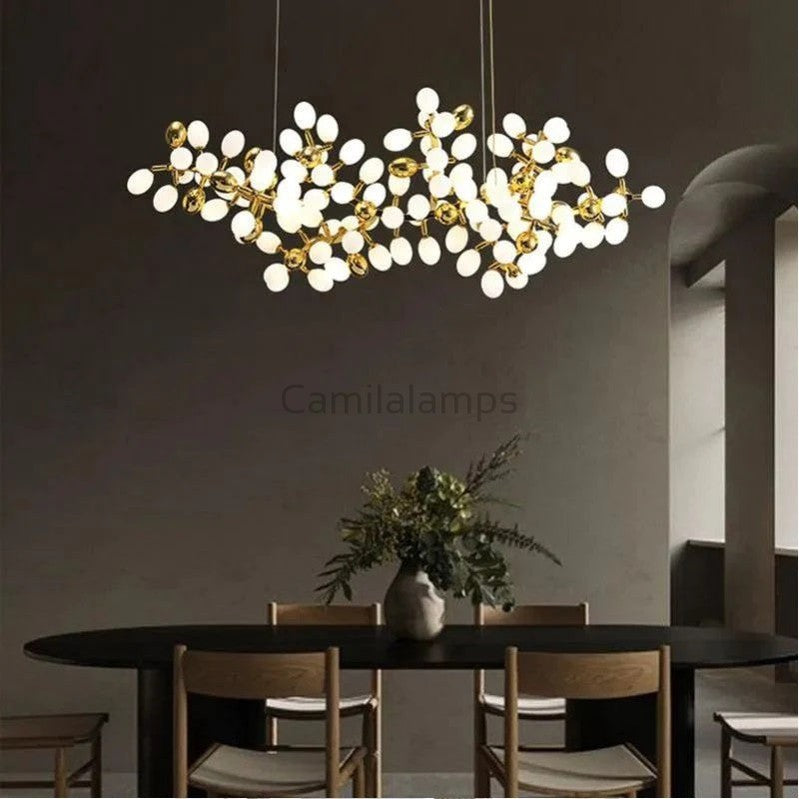 The collection of chandeliers is inspired by the growth dynamics of the vine plant grape. The frame of the branches is handmade and the cups are made of balls in the shape of grapes in milk white and gold. It is an elegant and charming lamp for banquets, living room foyers.